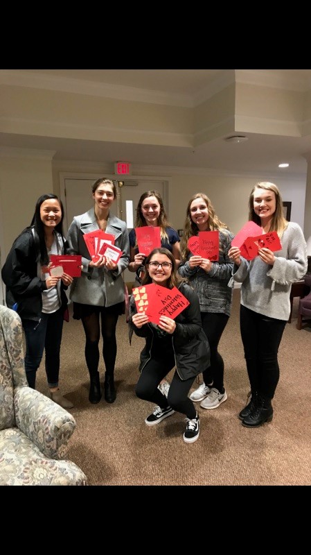 girls holding valentine cards